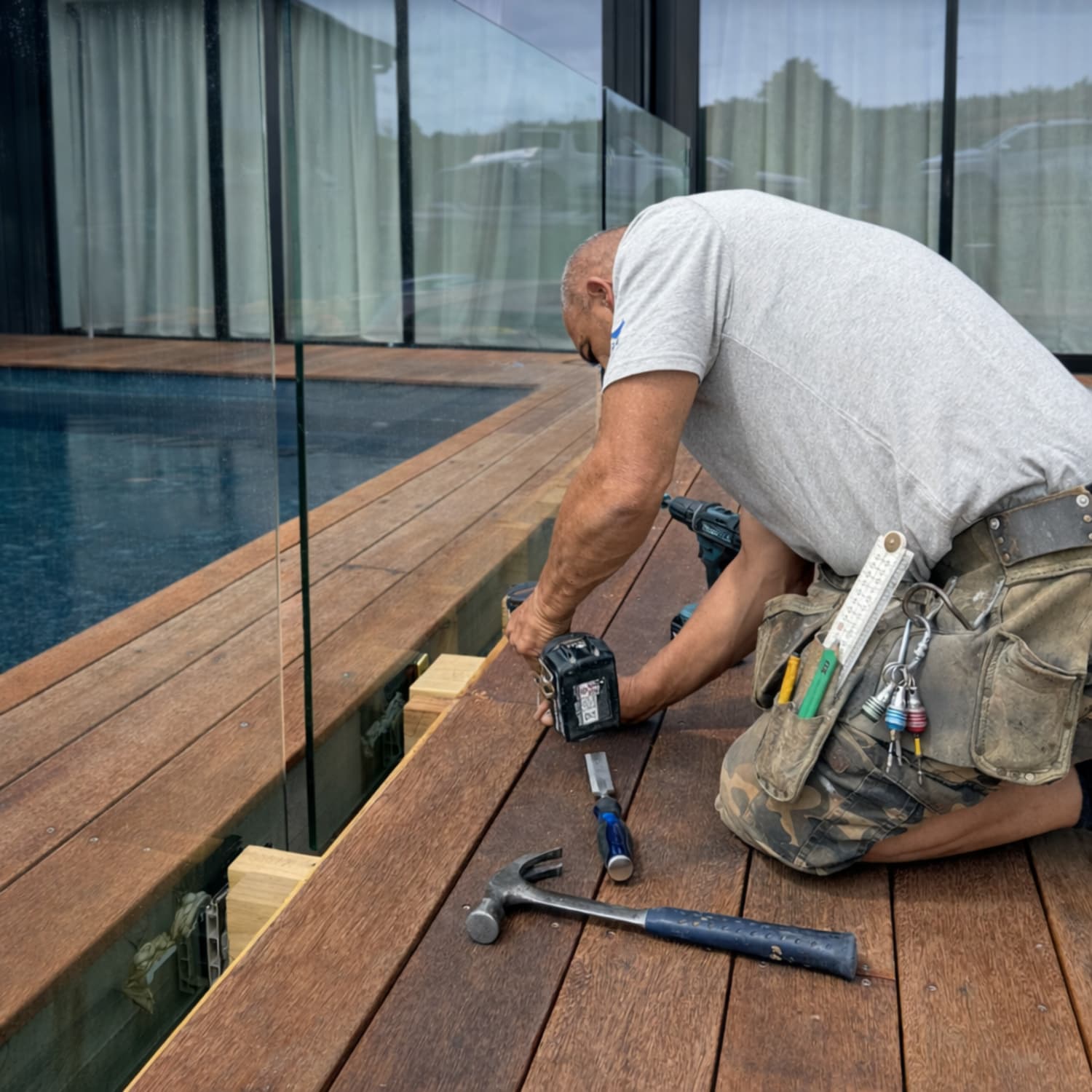 A Finer Builds tradesperson on site, tools in hand.